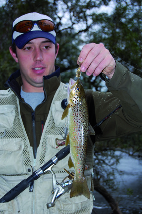 Andy with a brown trout caught on a Celta. These shallow running lures worked well in the moving water because they could be quickly retrieved and kept above the slime-covered river rocks.